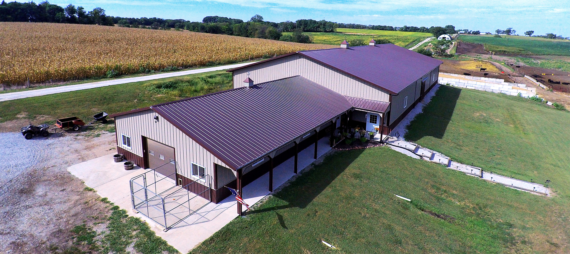 Large suburban building on farmland bordering a crop field